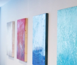 Canvas art works along a wall